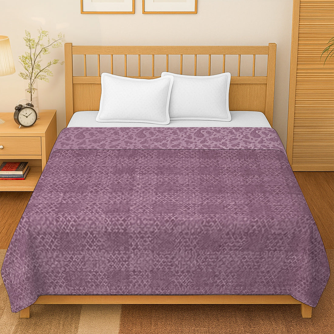 Purple patterned bedsheet on a wooden bed with white pillows in a modern bedroom