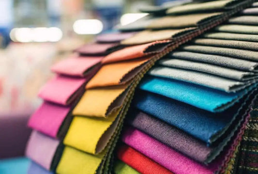 Assorted colorful fabric swatches neatly stacked for bedding and home textiles