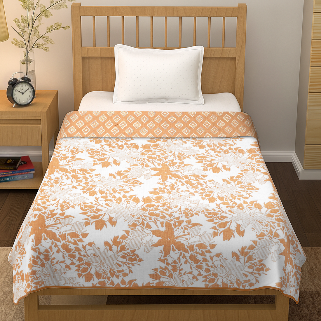 Single bed with floral orange and white bedsheet, white pillow, modern bedroom decor