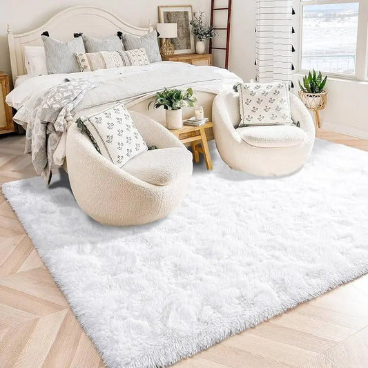 Cozy modern bedroom with white fluffy rug, accent chairs, bed, pillows, and home decor