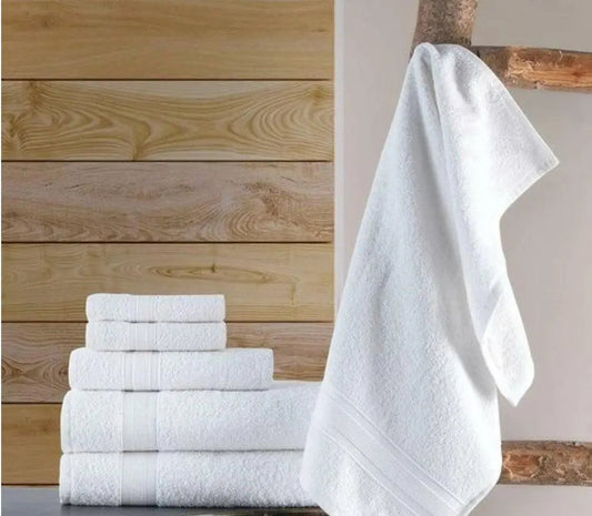 White cotton hand towels stacked and hanging in a modern bathroom setting