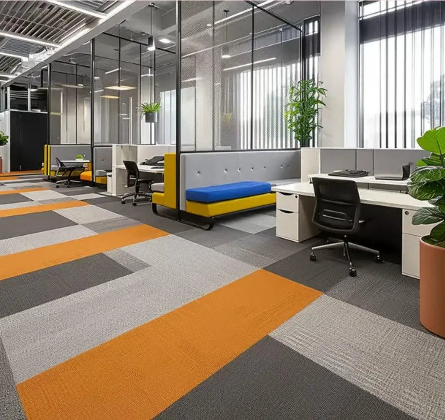 Modern office space with colorful carpet tiles, workstations, and large windows