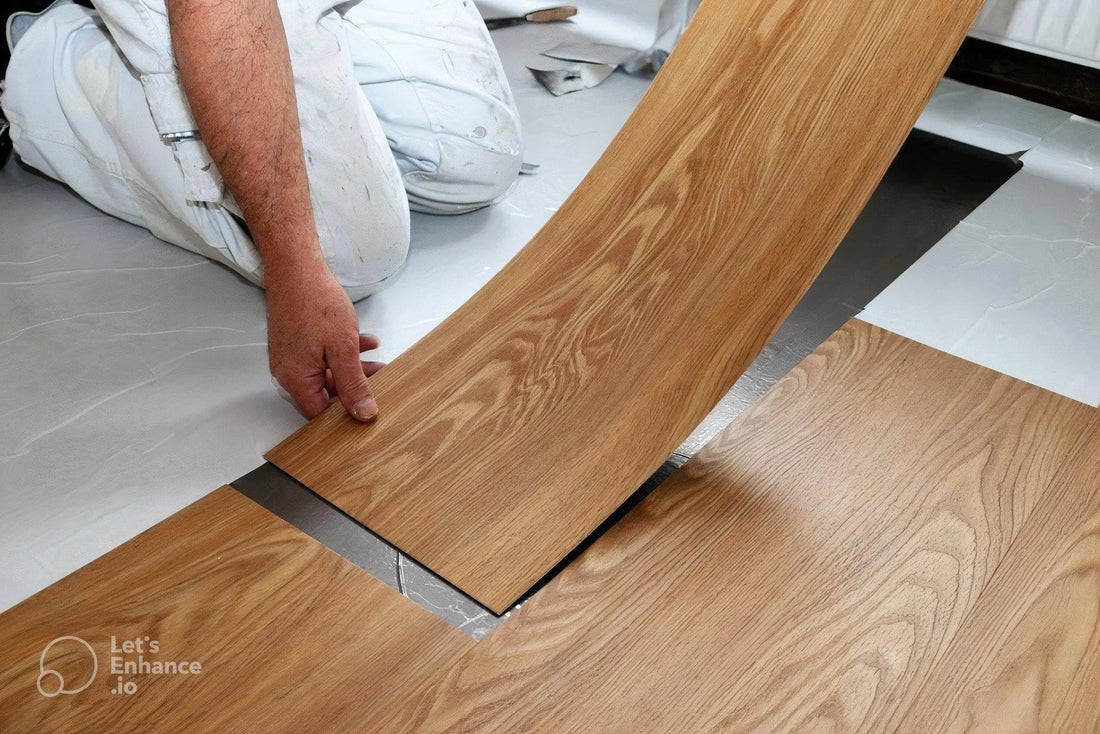 Person installing wood-look PVC floor covering sheets on indoor floor
