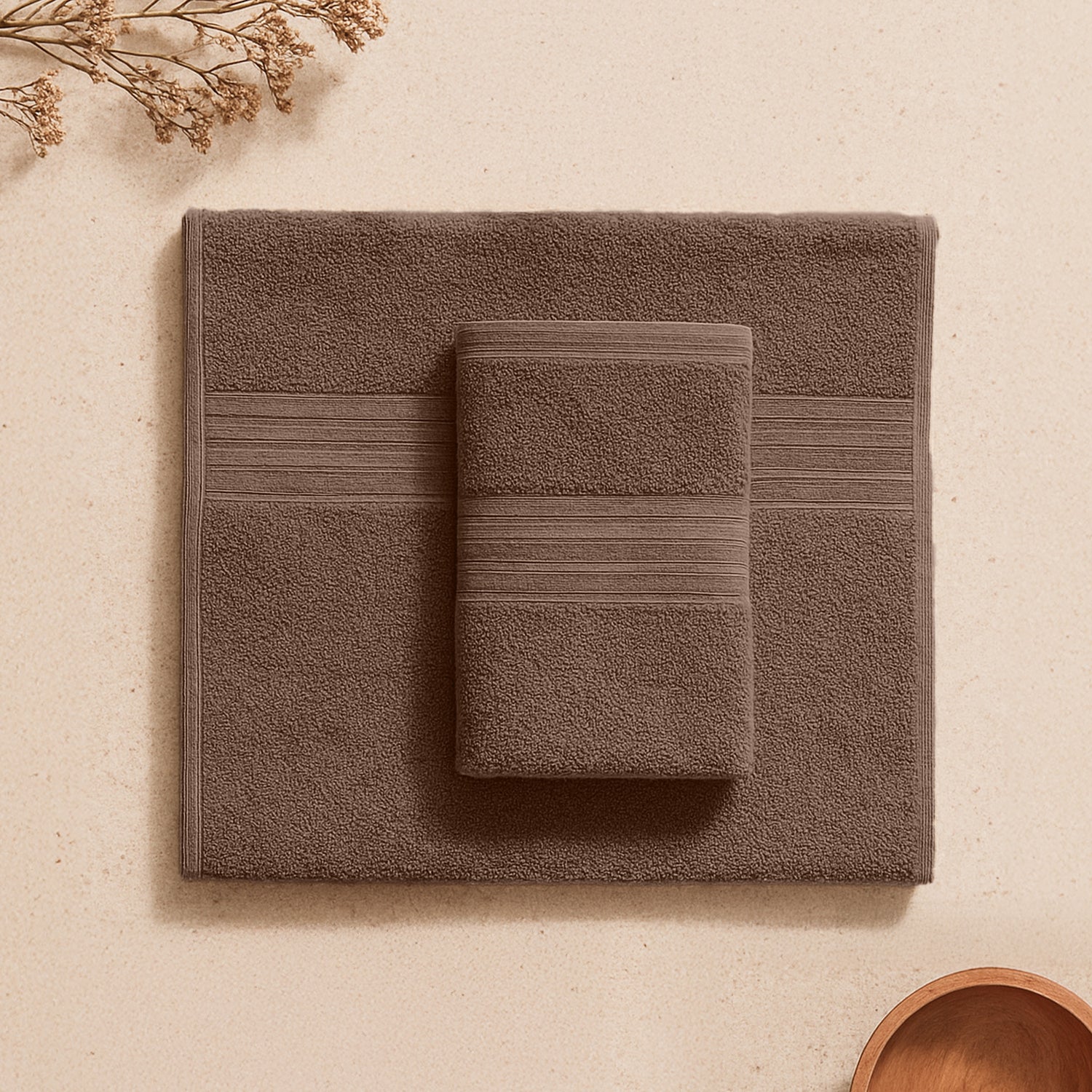 Walnut brown towel set with textured stripes on beige background, bathroom essentials