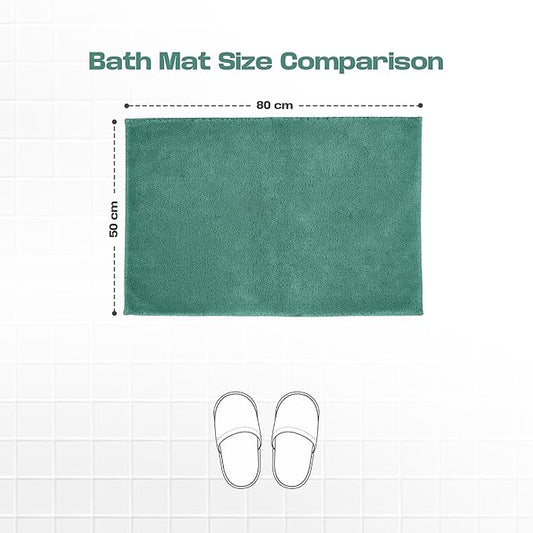 Green bath mat 50x80 cm on tiled floor with slippers for size comparison.