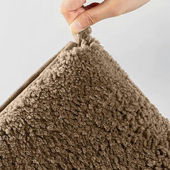 Hand holding a fluffy brown cushion, textured pillow for bedroom decor