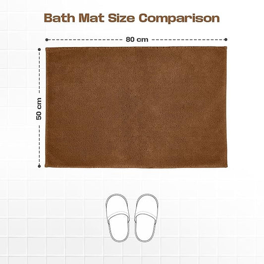 Brown bath mat size 50x80 cm on tiled floor with slippers for scale