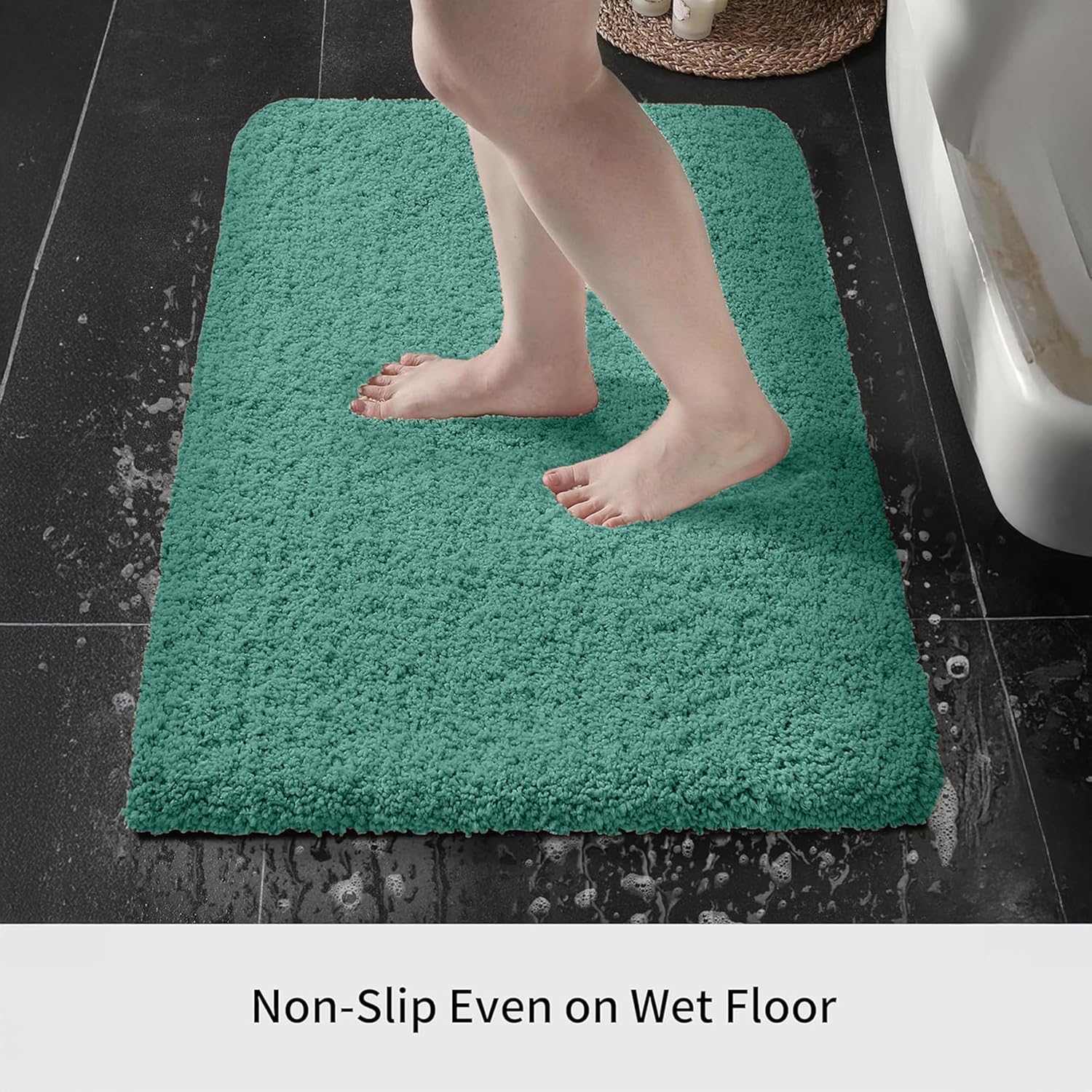 Aqua blue non-slip bath mat on bathroom floor with wet feet stepping on it