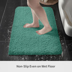 Aqua blue non-slip bath mat on bathroom floor with wet feet stepping on it