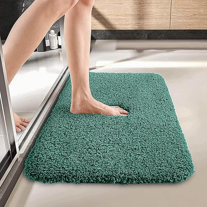 Person stepping onto a soft, teal bathmat in a modern bathroom setting