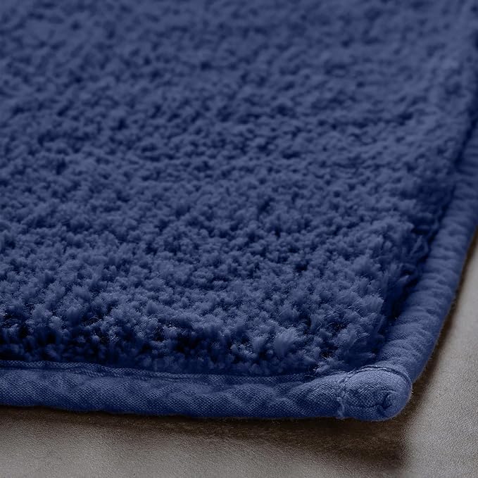 Soft blue microfiber bathmat close-up, textured surface and stitched edge detail