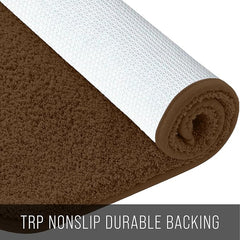 Brown bathmat with textured non-slip backing, rolled to show soft pile and durable base