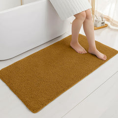 Soft brown bathmat in bathroom with person stepping out of bathtub, modern decor