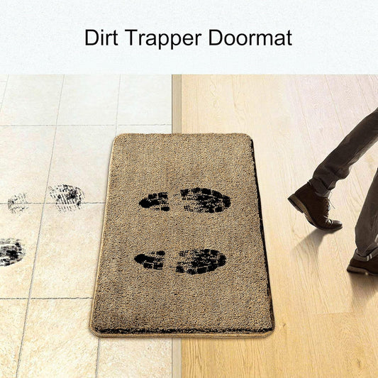 Beige dirt trapper doormat with black footprint prints at entryway, catching dirt from shoes.
