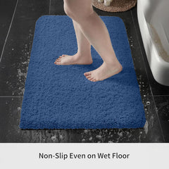 Blue non-slip bathmat on wet bathroom floor with bare feet stepping on it