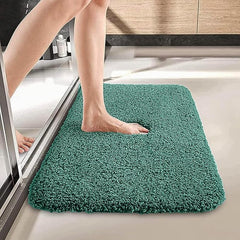 Person stepping onto a soft, teal bathmat in a modern bathroom setting