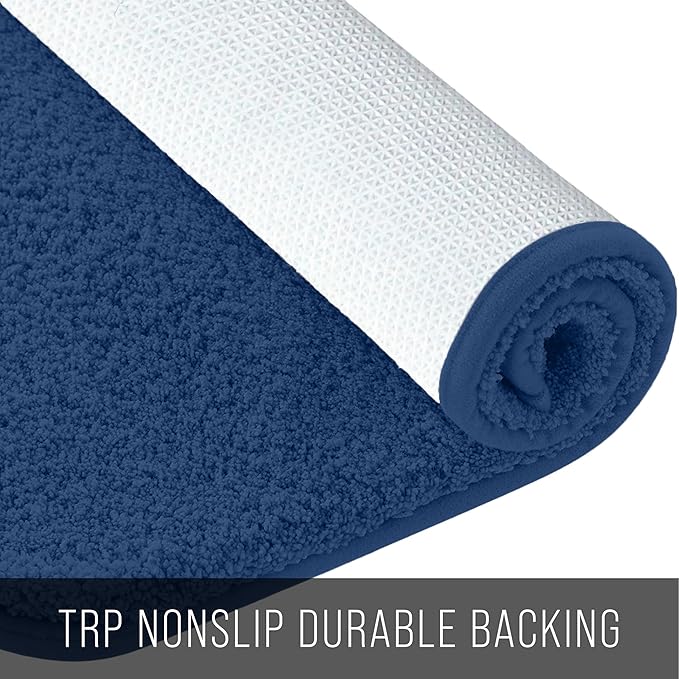 Blue bathmat with soft textured surface and non-slip white backing, rolled up
