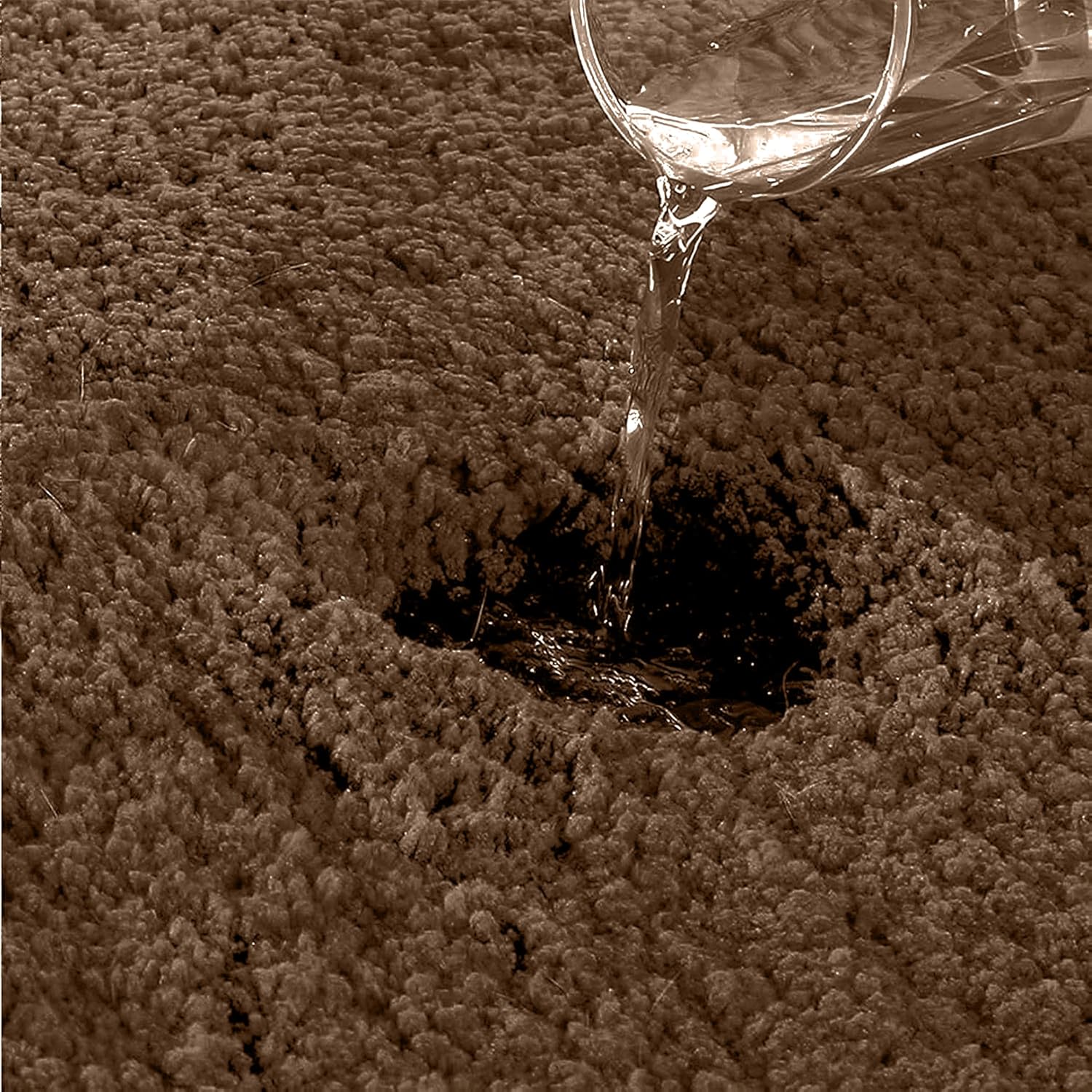 Water being poured onto an absorbent, textured bathmat surface