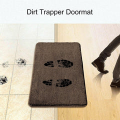 Brown dirt trapper doormat with muddy footprints on tile and a person stepping onto it