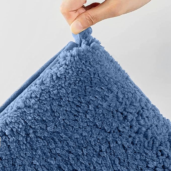 Hand holding a soft blue sherpa pillow with plush textured surface