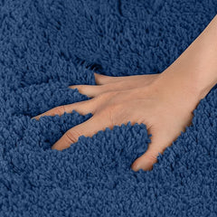 Hand pressing into soft blue shaggy bathmat showcasing plush texture