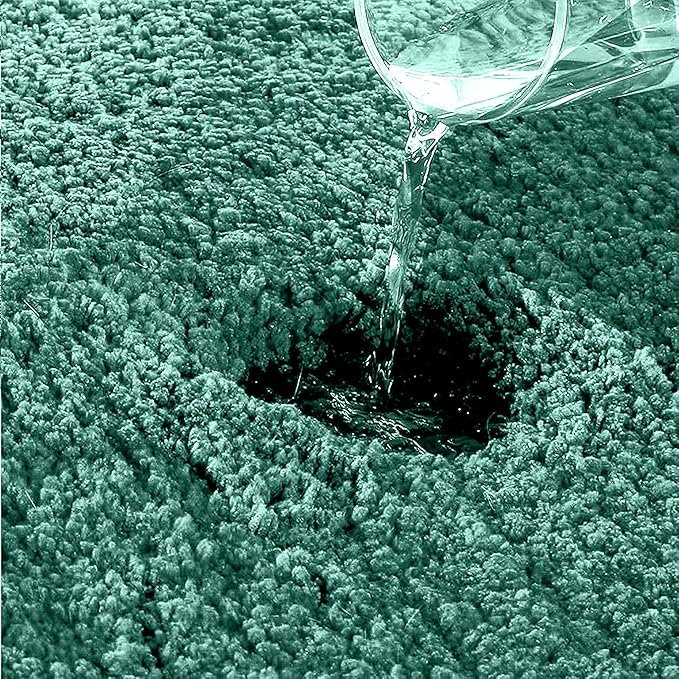 Water being poured onto an absorbent, textured bathmat surface