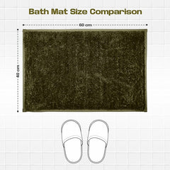 Dark green bath mat 60x40 cm on white tile with slippers for size comparison