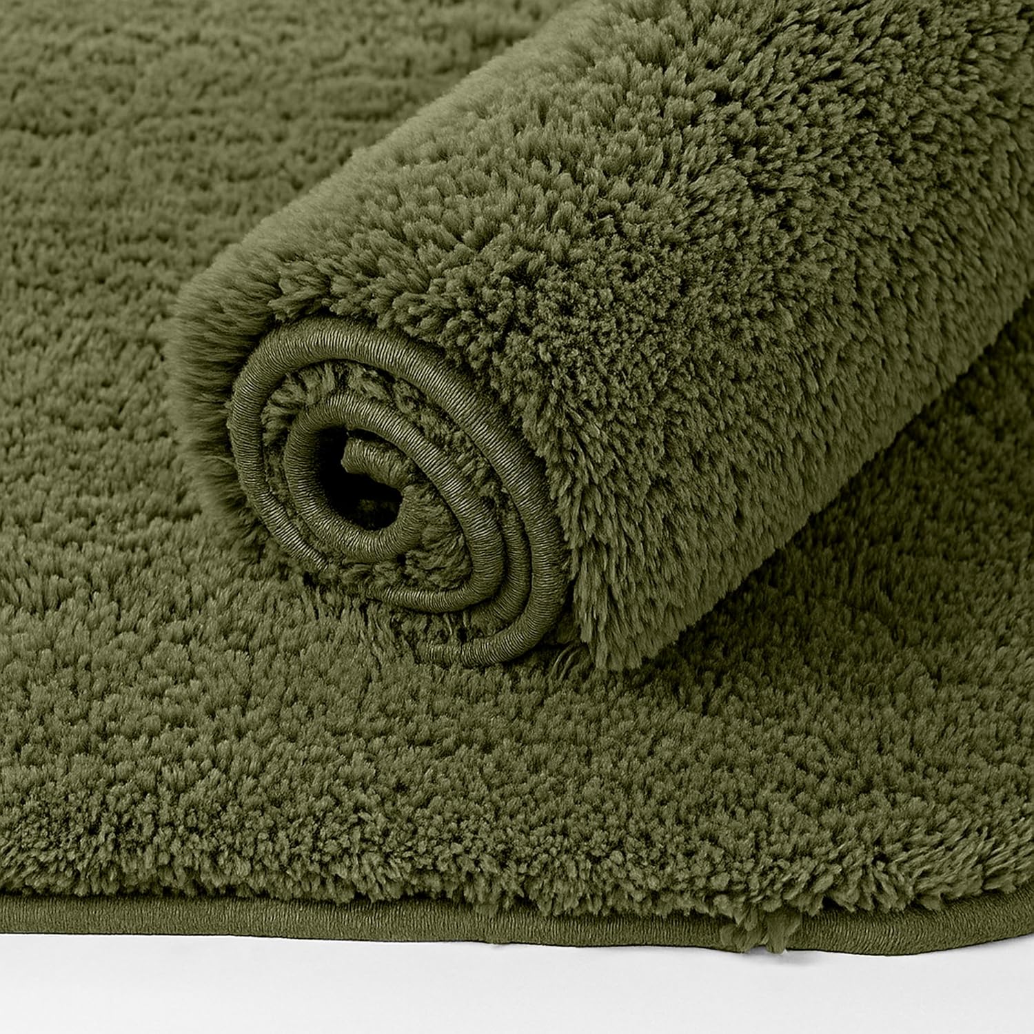 Rolled olive green bathmat with soft, plush texture, ideal for bathroom decor