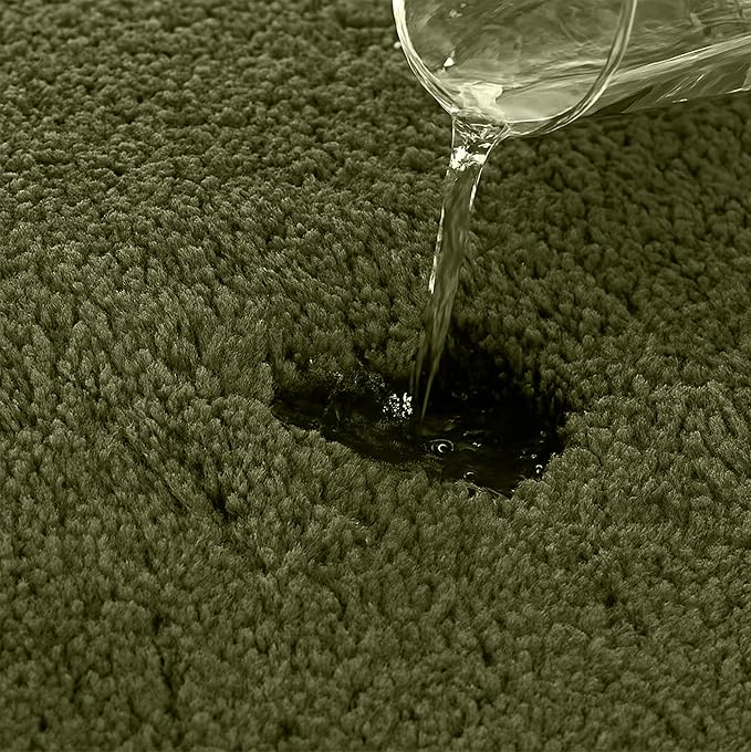Water being poured onto a soft absorbent bathmat, demonstrating water absorption.