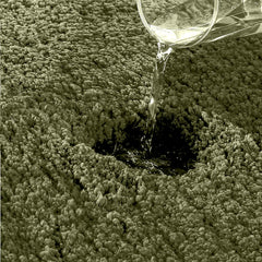 Water being poured onto absorbent bathmat surface, demonstrating liquid absorption