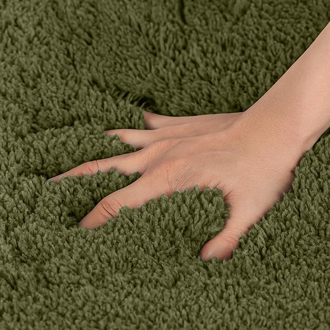 Hand pressing into soft green fluffy bathmat, showcasing plush bathroom rug texture