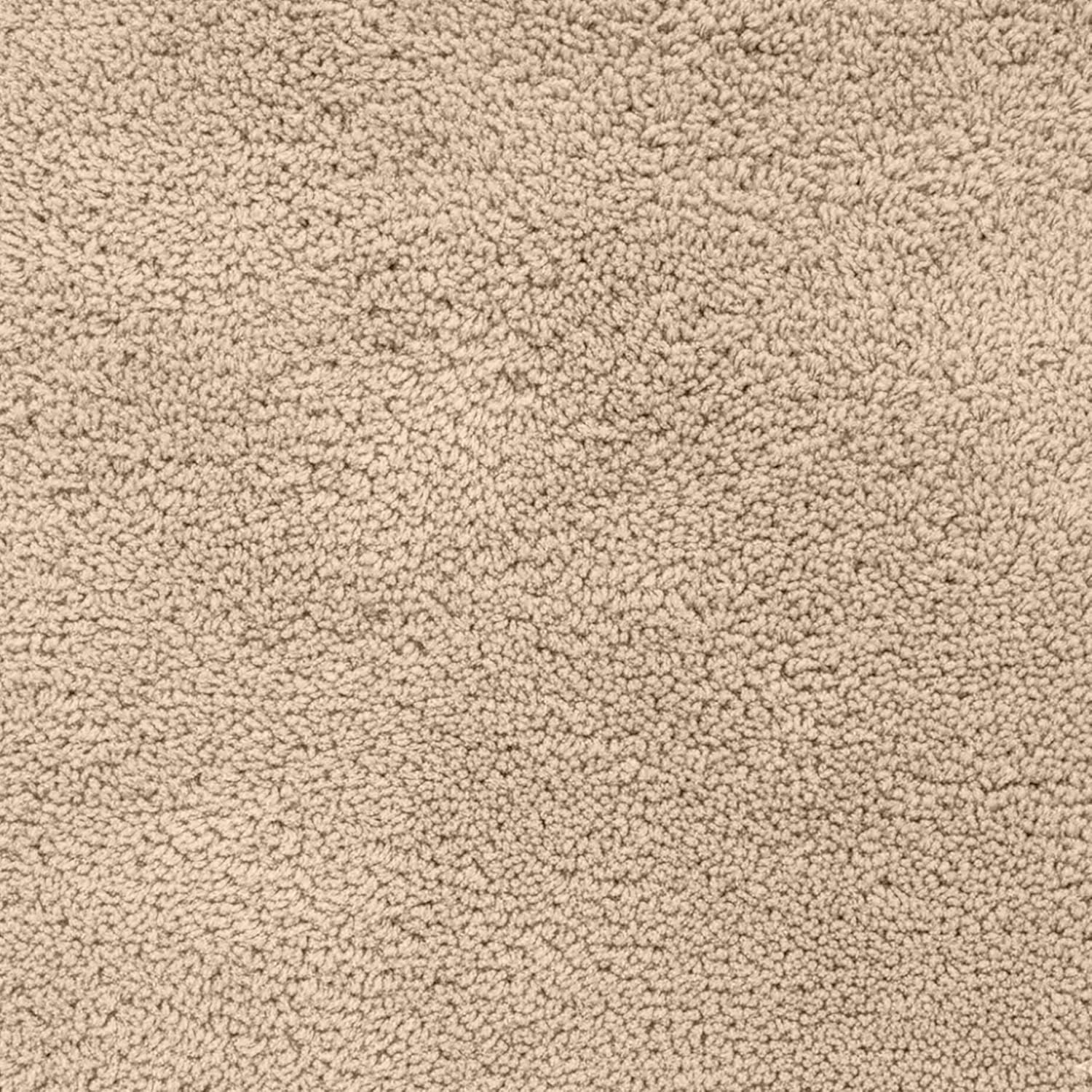 Close-up of a beige, soft, textured bathmat surface for bathroom decor