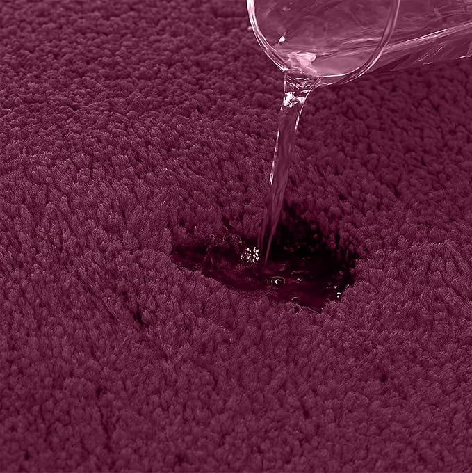 Water being poured onto absorbent maroon bathmat surface, showcasing water resistance