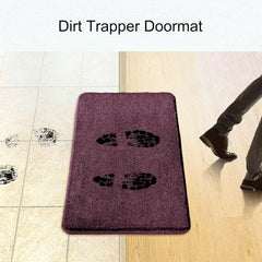 Purple dirt trapper doormat on tile floor with muddy footprints and person stepping on mat