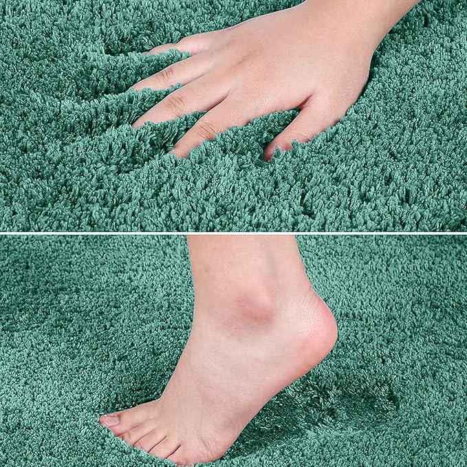 Soft green bathmat with hand and foot pressing into plush, absorbent microfiber pile