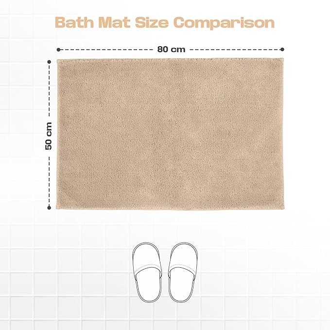 Beige bath mat 50x80 cm on tiled floor with slipper outline for size comparison