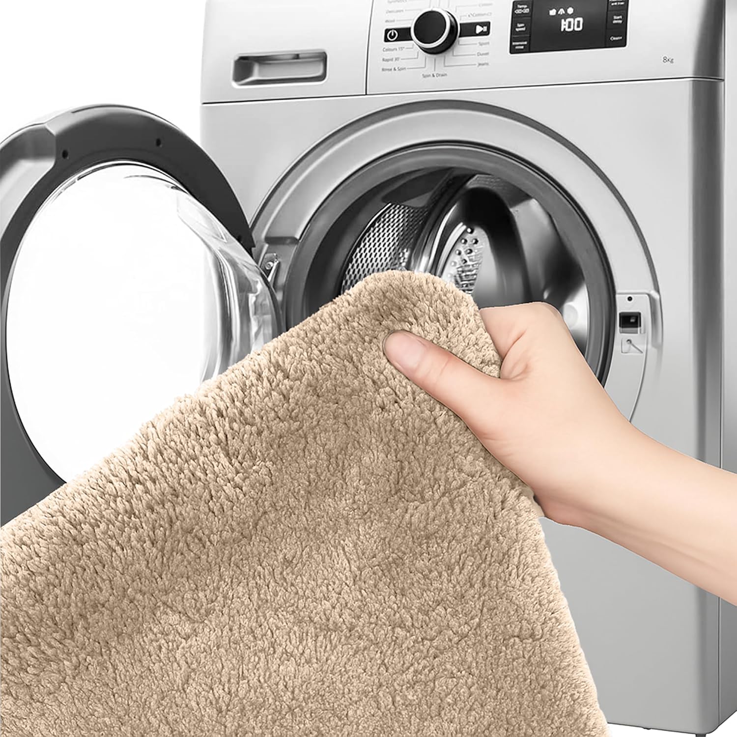 Hand holding a beige bathmat in front of an open washing machine