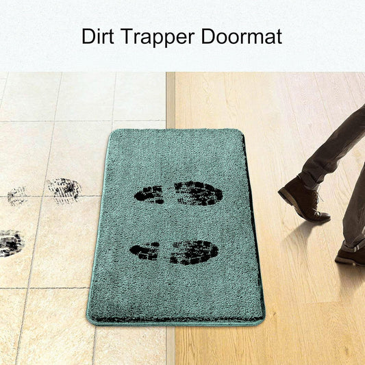 Absorbent dirt trapper doormat capturing muddy footprints at doorway on tile and wood floor