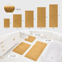 Various sizes of gold plush bathmats displayed in a modern bathroom with bathtub and toilet.